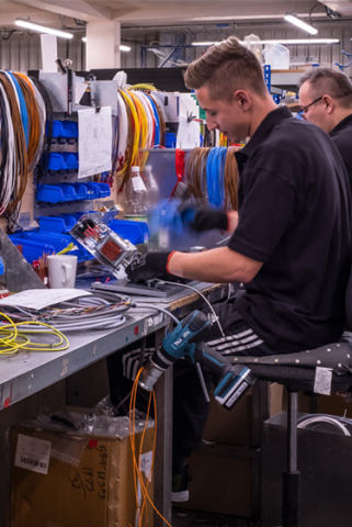 Engineer adding controls wiring inside fan coil unit
